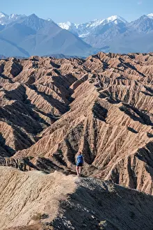Experience: Hiker walking along a canyon, Tian Shan mountains