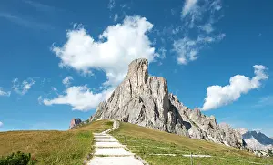 Hiker: Hiking trail at Passo Giau with summit La Gusela