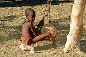 Churning: Himba boy - churning milk