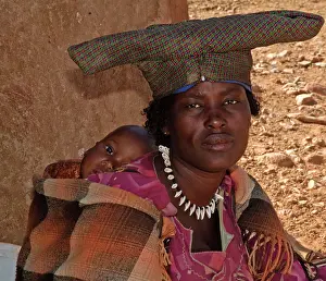 Adopt: Himba lady with child - some of the tribe no longer