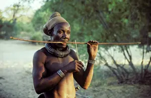 Instruments: Himba man playing a stringed instrument - the head