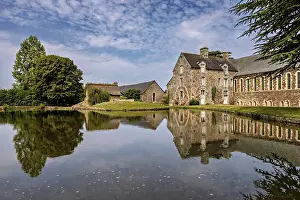 Castle: Historic castle on the shore of a lake with a clear reflection and surrounded by trees
