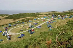 Tents: Holiday tents and caravans on sloping fields on cliffs
