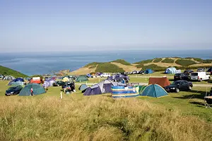 Tents: Holiday tents and cars on sloping fields on cliffs