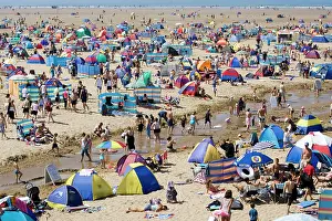 Tents: Holidaymakers with tents, umbrellas and windbreaks