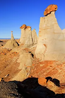 Amidst: Hoodoos - eroded clay sculptures with rocks balanced