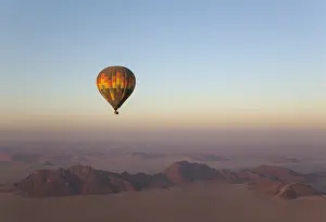 Namibrand: The hot-air balloon above an arid plain and isolated