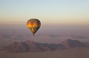 Namibrand: The hot-air balloon above an arid plain and isolated