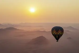 Remote: The hot-air balloon above an arid plain and isolated mountain ridges at the edge of the Namib Desert