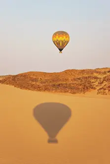Remote: The hot-air balloon above an arid plain and isolated mountain ridges at the edge of the Namib Desert