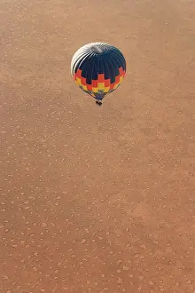 Recent: Hot-air balloon above a sandy plain at the edge