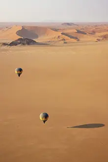 Remote: Two hot-air balloons above an arid plain at the edge of the Namib Desert