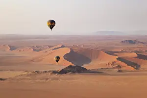 Remote: Two hot-air balloons at the edge of the Namib Desert