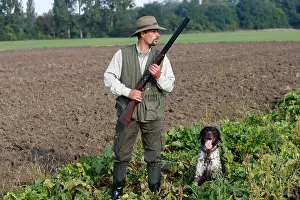 Guns: Hunting / shooting - man with gun and Small Munsterlander