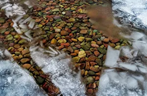 Montana: Ice formations above the colorful rocks along the shore of