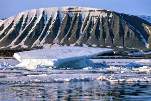 Sheet: Ice sheet in a fjord at a mountain with snow in