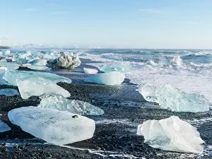 Sparkling: Iceberg on black volcanic beach. North Atlantic