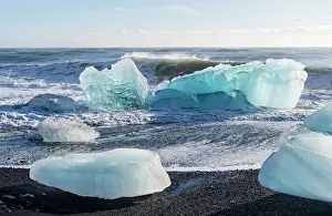 Cemetery: Iceberg on black volcanic beach. North Atlantic
