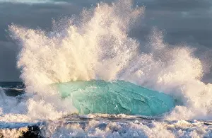 Cemetery: Iceberg on black volcanic beach. North Atlantic