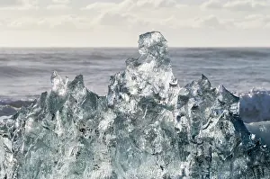 Cemetery: Iceberg on black volcanic beach. North Atlantic