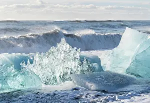 Cemetery: Iceberg on black volcanic beach. North Atlantic