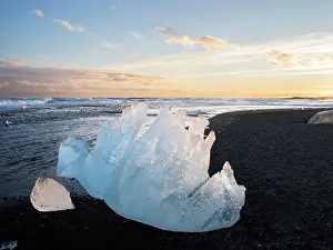 Cemetery: Iceberg on black volcanic beach. North Atlantic