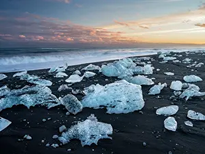 Cemetery: Iceberg on black volcanic beach. North Atlantic