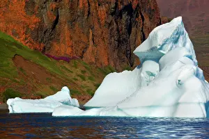 Drifting: Iceberg drifting in front of coastline Arctic ocean Summer