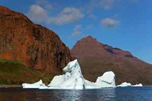 Drifting: Iceberg drifting in front of coastline Arctic ocean Summer