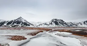 Vesturland: Icy landscape, volcanic black mountains with snow
