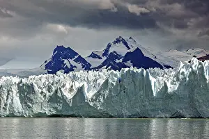 Glaciers: Imposing glacier merges with snow-covered mountains and sky