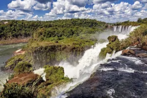 Waterfalls: Impressive waterfall with foaming river and lush vegetation