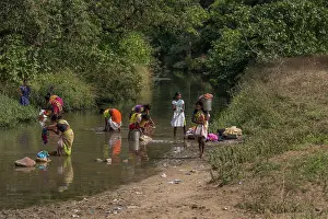 Laundry: India women washing clothes in narrow river