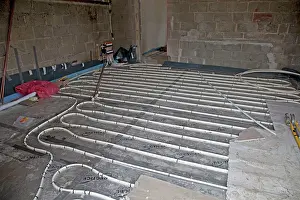 Heating: Installing underfloor heating pipes in new office building