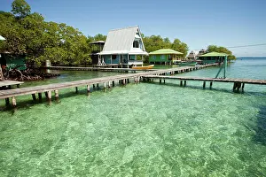 Timber: Jetty in the clear water and a typical wooden house