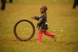 Tire: Kalenjin boy, playing with tire, near Eldoret, Rift