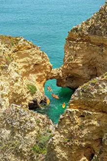 Paddle: Three kayaks in the turquoise sea sailing through