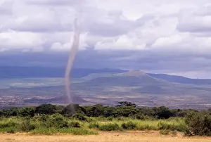 Funnel: Kenya, Amboseli. Dust devil on plain below