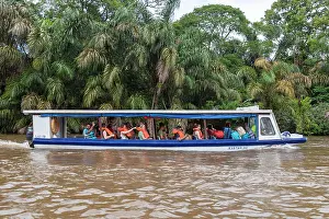 Ride: La Pavona, Costa Rica, Tourists ride boats on the