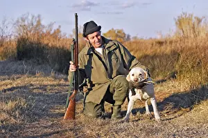 Retrieving: Labrador - with hunter, carrying gamebird in mouth
