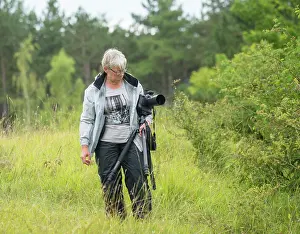 Namen: A Lady is searching for objects for Macrophotography on a Chalk hill
