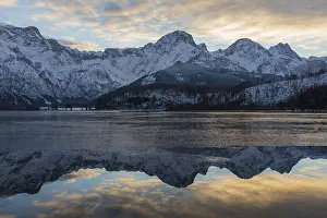 Journey: Lake Almsee in winter. Snow on the mountains and some clouds in the sky