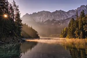 Reflect: Lake at sunrise with fog, mountains and reflection