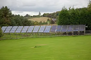 Delivering: Large array solar PV panels on metal frame in field