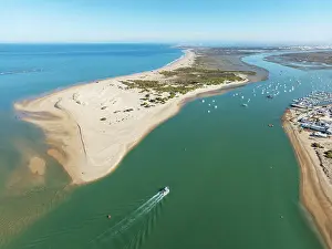 Boats: The large sandbar of Punta del Boquerón and partial view of the fishing village of Sancti Petri
