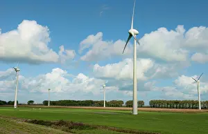 Mills: Large wind mills generating energy in farmland