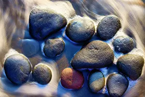 Blur: Lava beach rocks worn by centuries of sea water cover the