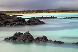 Lava: Lava rocks along tranquil shoreline of San Cristobal
