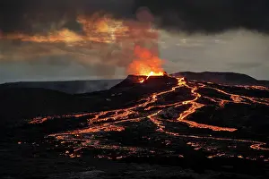 Spurting: Lava spurting out of crater and reddish illuminated