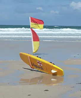 Paul Felix: Lifeguards Surfboard and warning flags on beach